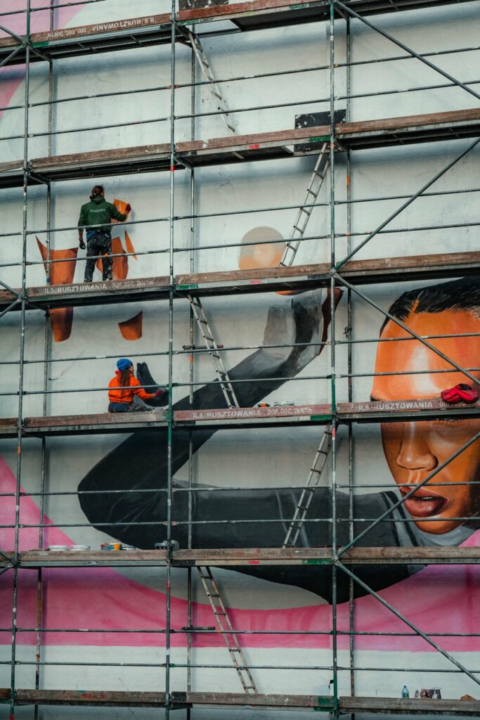 Fresque de façade peinte depuis un échafaudage